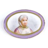 A large Victorian oval miniature painted brooch, depicting an elderly lady on a ceramic panel, in