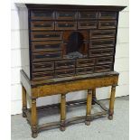 An 18th century collector's cabinet on stand, with 22 panel fronted drawers and arched central