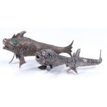 3 graduated silver articulated fish boxes with green glass eyes, largest length 17cm