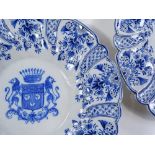 A pair of Delft tin-glazed pottery plates, with moulded surrounds and armorial centres, diameter