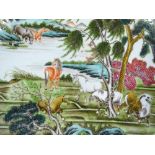 A Chinese porcelain charger, hand painted enamel horses in landscape with painted geometric