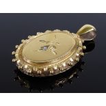 A Victorian ornate rolled gold oval locket, with diamond set front and engraved foliate back,