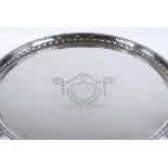 A circular silver waiter / card tray, with reeded edge on claw and ball feet, diameter 26cm, 17oz