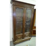 A walnut 2-door bookcase, circa 1900, with fluted columns and fielded panels, width 3'7", height 6'