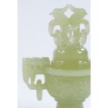 A Chinese carved jade incense burner and cover, with dragon decorated ring handles, height 17cm