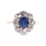An 18ct gold sapphire and diamond cluster ring, setting height 12.7mm, size N, 3.3g