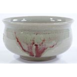 A Chinese celadon glaze porcelain bowl, with flashes of iron red colour, diameter 13cm