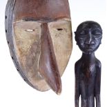 An old African painted wood bird-face mask, and an African carved wood standing figure, height