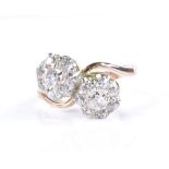 An 18ct gold diamond double cluster crossover ring, setting height 15.3mm, size S, 5.3g