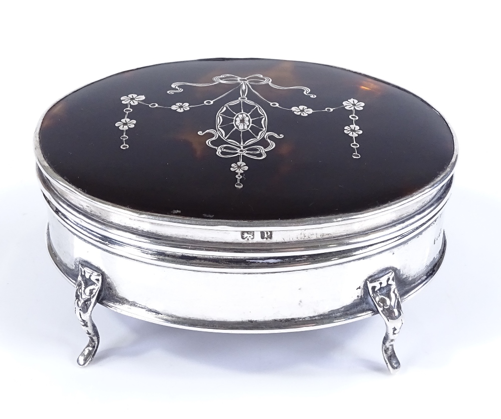 An Edwardian oval silver and tortoiseshell picquet inlaid jewel box, by E S Barnsley & Co, hallmarks