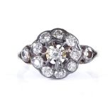 An 18ct diamond halo cluster ring, with open diamond set shoulders, setting height 11.3mm, size M,