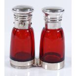 A Victorian Cranberry glass and unmarked white metal-mounted double-ended perfume bottle, with