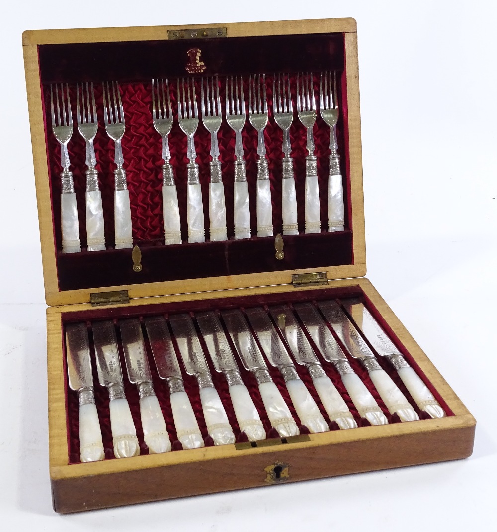 A cased set of Victorian carved mother-of-pearl handled dessert knives and forks for 12 people (