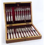 A cased set of Victorian carved mother-of-pearl handled dessert knives and forks for 12 people (