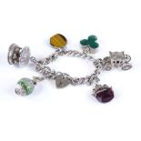 A silver curb link charm bracelet with heart lock, set with 6 charms, 83.2g