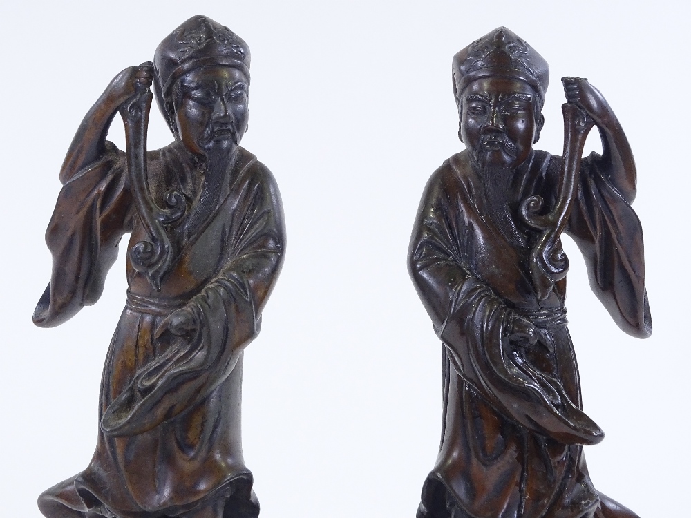 A pair of Chinese patinated bronze standing figures, circa 1900, height 26cm