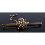 A 9ct gold figural spider bar brooch, set with sapphire head and yellow-stone body, yellow stone