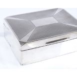 An Art Deco rectangular silver cigarette box, with engine turned lid and canted corners, by J B