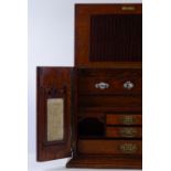 A Victorian oak stationery cabinet, the interior fitted with perpetual calendar, drawers and