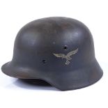 A German Army tin helmet with decals but no insert