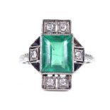 An Art Deco 18ct white gold emerald, diamond and onyx panel ring, rectangular-cut emerald approx