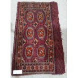 An Antique Tekke Juval red ground rug, with multiple borders and skirt panel, 4'3" x 2'7"