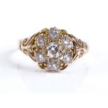 A Victorian 15ct gold diamond cluster flowerhead ring, with scroll engraved shoulders, setting