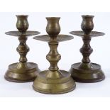 A set of bronze candle stands, height 14cm