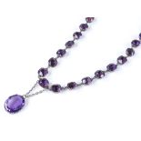 An Antique silver and amethyst collar necklace, with closed-back settings and oval-cut amethyst