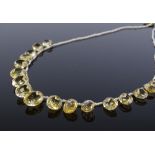 An Antique oval-cut graduated citrine and seed pearl necklace, with unmarked yellow metal clasp,