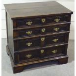 An 18th century joined-oak chest of 4 long graduated drawers, with panelled drawer fronts and