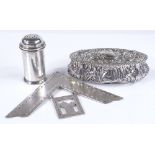 A relief embossed oval silver box, a silver cylindrical pepperette, and a silver Masonic jewel,