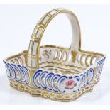 A small 19th century Derby porcelain basket, with painted and gilded decoration, 10cm across