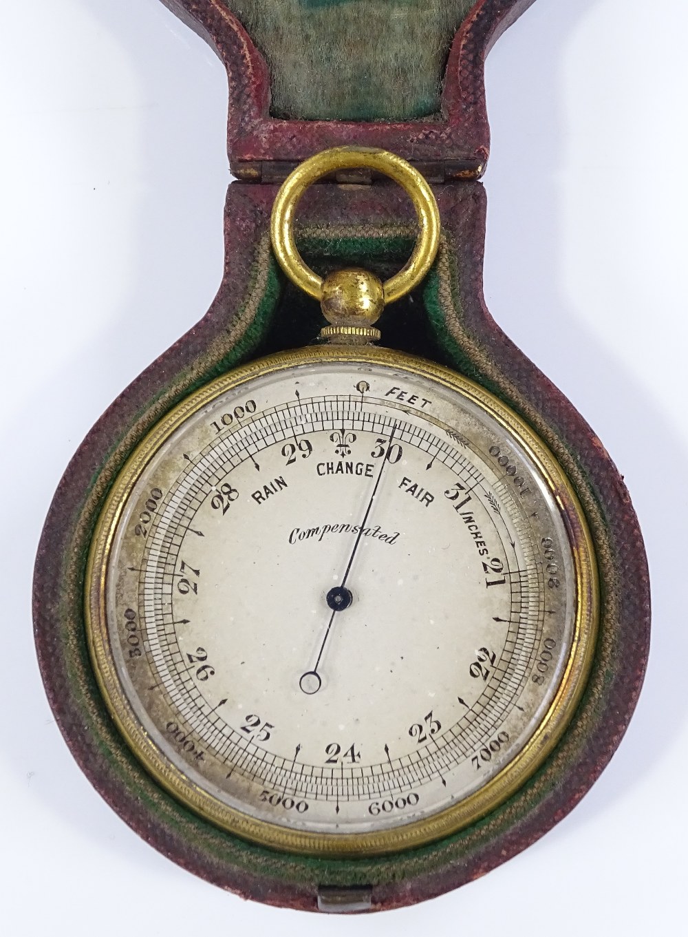 A 19th century pocket barometer, with silvered dial, gilt-metal case, in original red leather