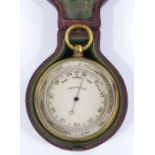A 19th century pocket barometer, with silvered dial, gilt-metal case, in original red leather