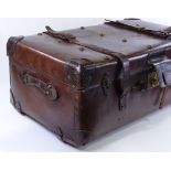 A large brown leather travelling trunk with brass studs, 82cm x 47cm x 34cm