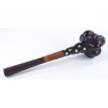 A carved and mother-of-pearl inlaid hardwood Tribal club, length 47cm