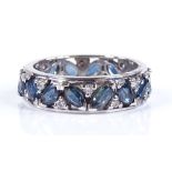 An 18ct white gold sapphire and diamond eternity ring, set with marquise-cut sapphires and round-cut