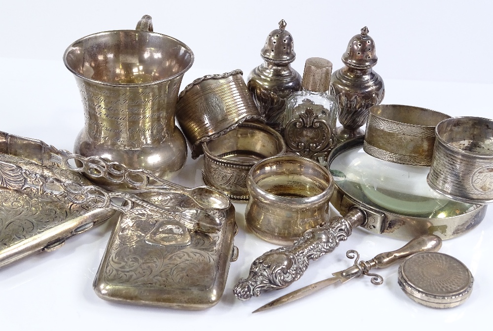 Various silver items, including a thistle shaped mug, a curved cigarette case, napkin rings etc,