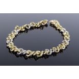 A 2-tone 9ct gold flat curb link bracelet, maker's marks ST, length 200mm, 18.2g