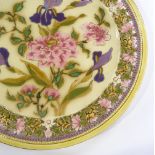 A Zsolnay Pecs ceramic charger, with pierced floral decorated border and hand painted iris design