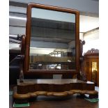 A Victorian mahogany swing toilet mirror of serpentine form, W60cm