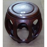 An Oriental hardwood barrel design jardiniere stand, H34cm