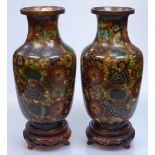 A pair of Chinese floral decorated cloisonne enamel vases on wooden stands, height 10"