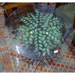 An unusual painted wrought-iron occasional table, in the form of a tree, with circular bevelled-edge