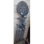 A large African Ashanti ornamental carved wood comb, surmounted by a seated figure, height 33"