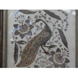 A pair of Indian / Oriental silver braid embroideries on silk grounds, depicting exotic birds,