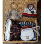 A modern wicker hamper containing handbags