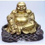 A Chinese bronze seated Buddha on carved hardwood stand, overall height 26cm, stand width 31cm