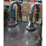 A pair of spelter wall light fittings, circa 1920, with painted bronze finish, and moulded glass